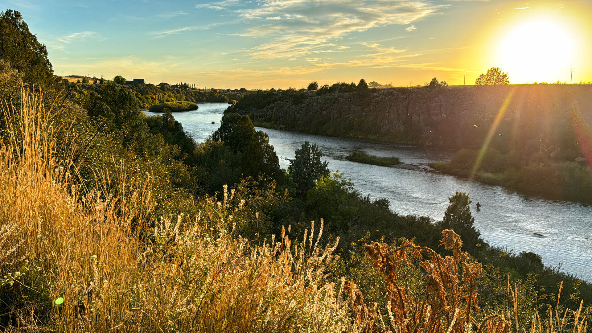 fly fisherman at sunset in a river gorge