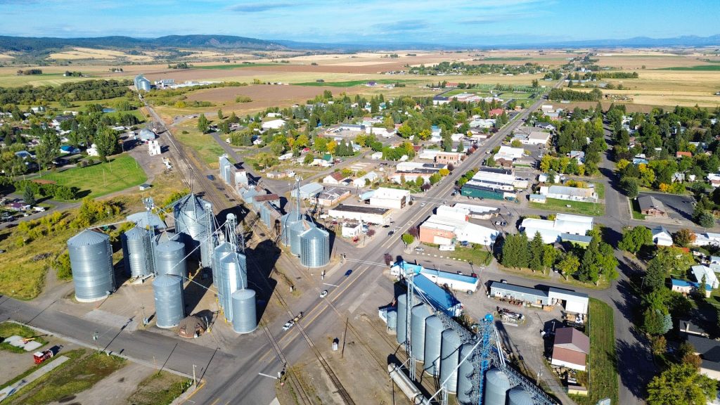 Aerial view of a small town main street, complete with grain silos and agricultural fields